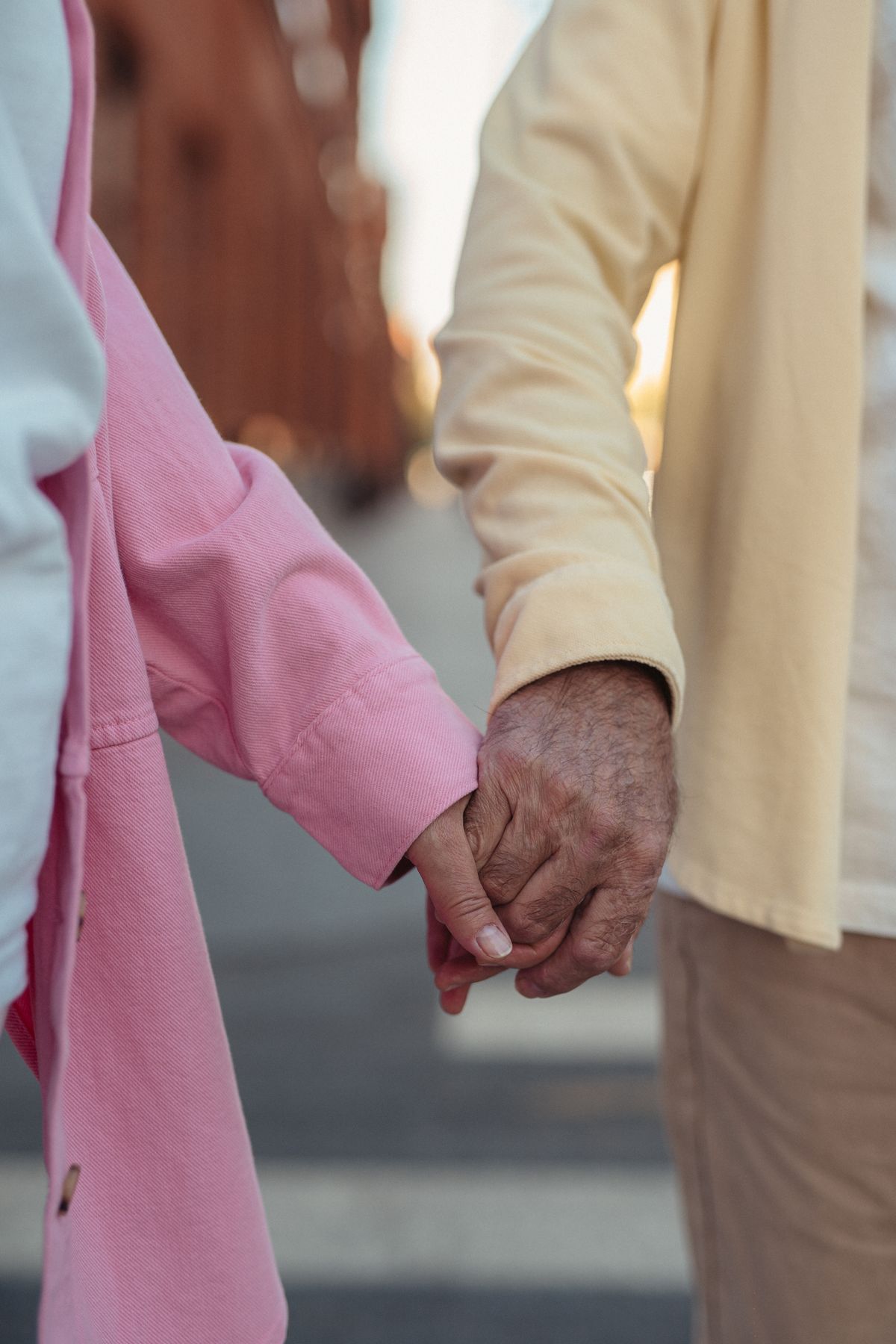 Close-up of an older couple holding hands, a symbol of companionship and connection after 60