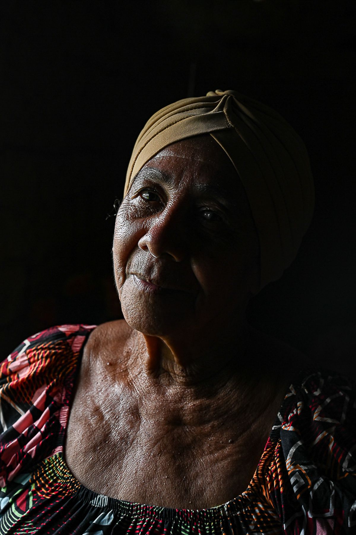 A thoughtful senior woman with a pensive expression, reflecting on a new chapter after loss