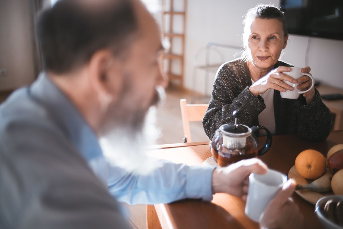 A senior couple enjoy a relaxed coffee date together, showing what dating over 60 can look like